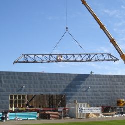 An image of a large crane constructing a building